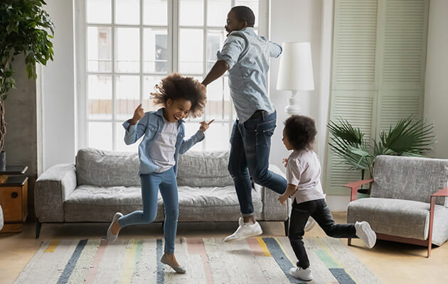 Large Family Laughing Dancing In House