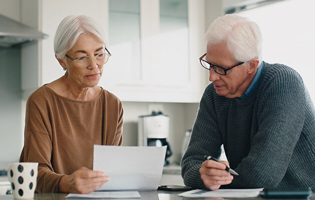 Large Senior Couple Calculating Bills