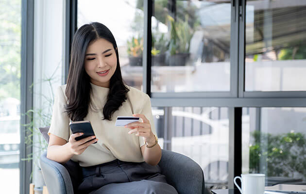 Large Women Holding Credit Card And Shopping Online