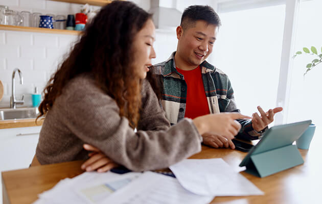 Large Asian Couple Working On Their Finance