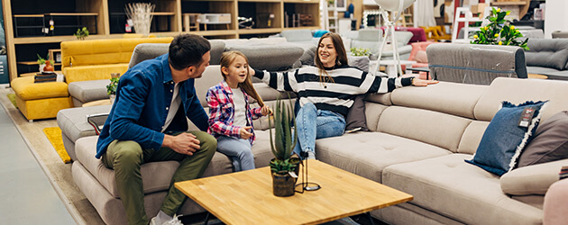 Medium Family With Kid Shopping For Furniture In Store