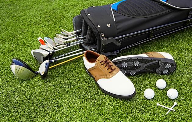 Large Golf Clubs And Shoes And Golf Balls On Golf Course