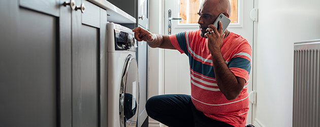 Medium Men Looking At Washer And Talking On The Phone