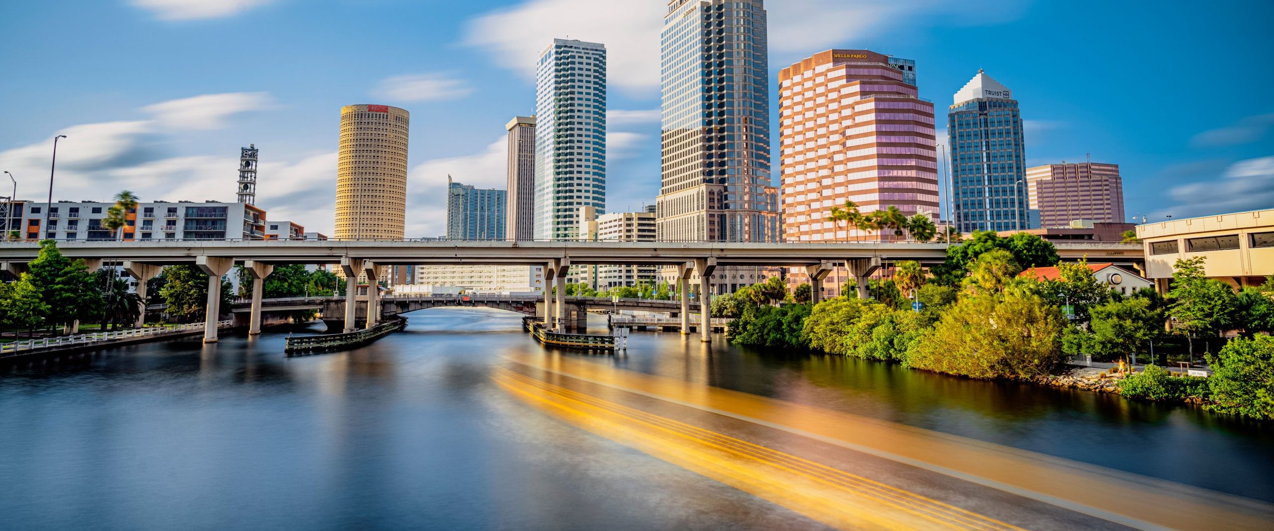 Skyline of downtown Tampa on the Hillsborough river under a blue sky