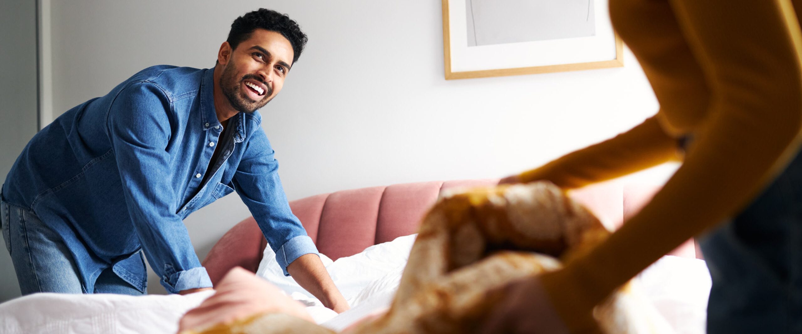 man making bed hero