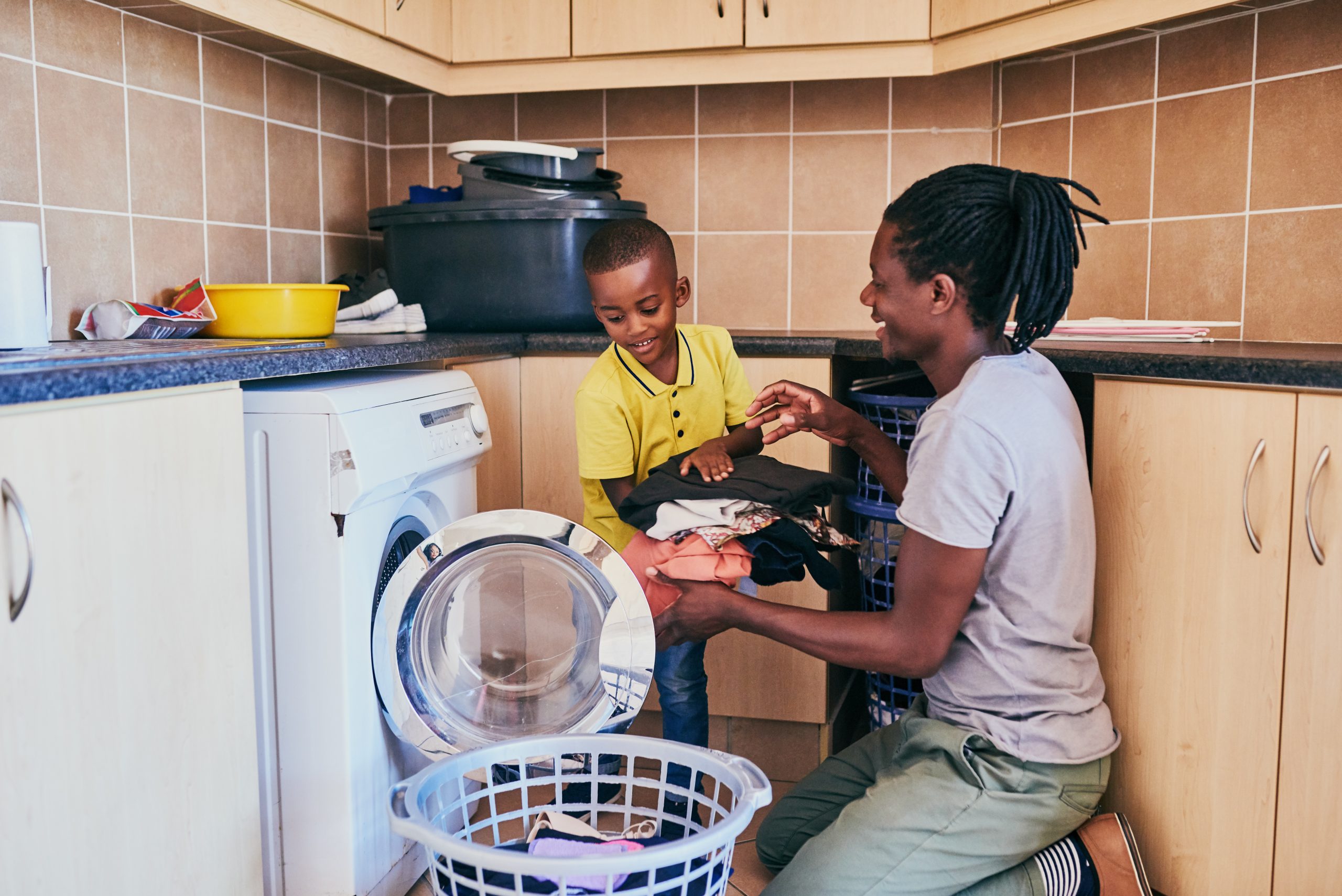 dad son doing laundry hero