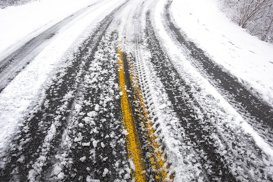Icy tire tracks on a snowy road