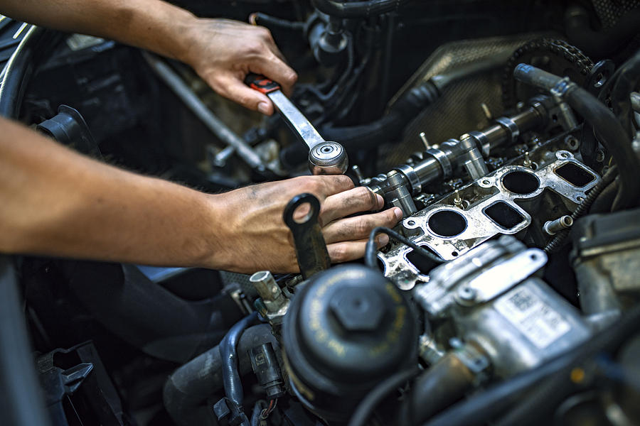 Working on an automotive engine using a ratchet on an exposed cylinder head.