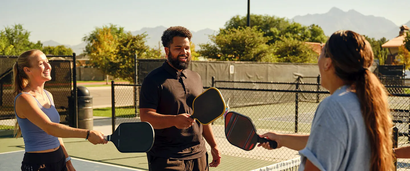 friends playing pickleball hero