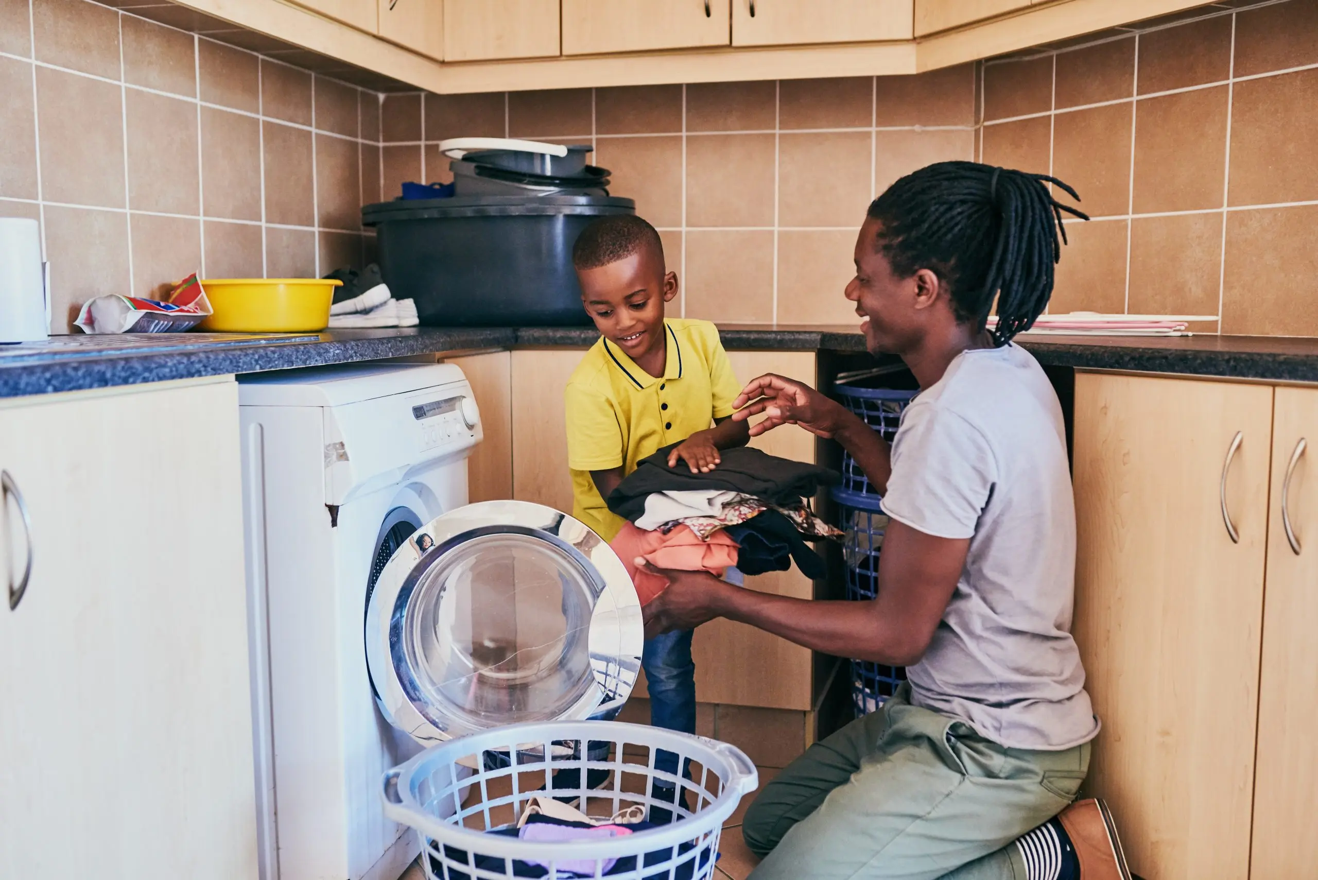 dad son doing laundry hero